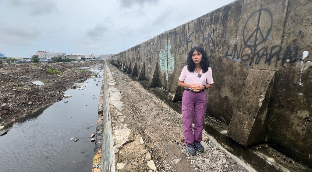 Adelia Dinda Sani on assignment reporting on the Giant Sea Wall project on the coast of Java